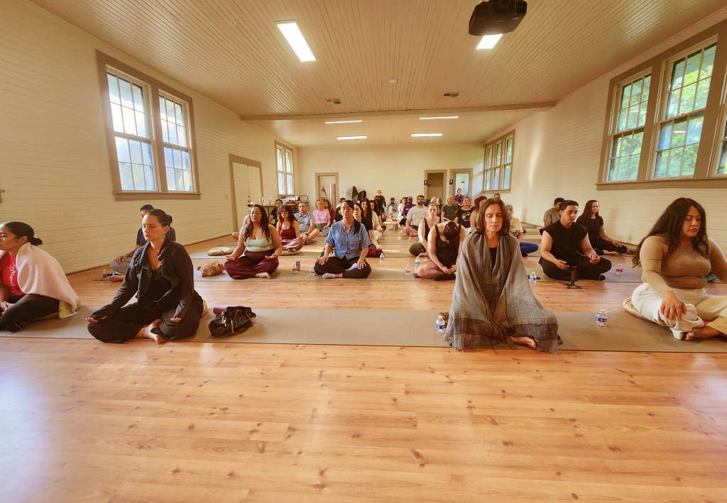Meditation practitioners sitting together in hall